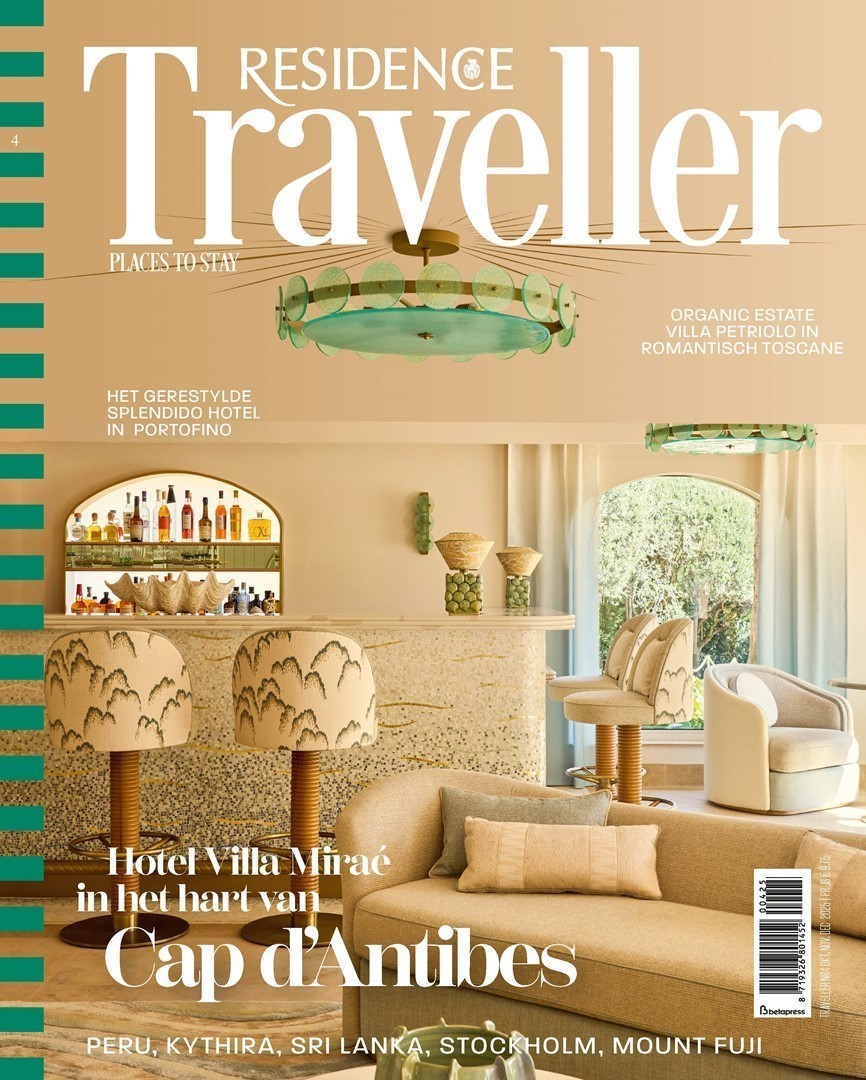 Cover van Residence Traveller nr. 4 met een zonnig interieurbeeld van Hotel Villa Miraé in Cap d’Antibes. Op de voorgrond een zandkleurige sofa met kussens, daarachter een bar met met mozaïek afgewerkte front en krukken met geborduurde patronen. Boven de bar hangt een opvallende groene designlamp.